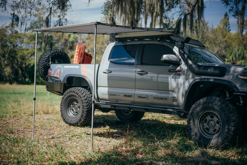 Load image into Gallery viewer, Rooftop awning attached to roof rails on a Toyota Tacoma truck
