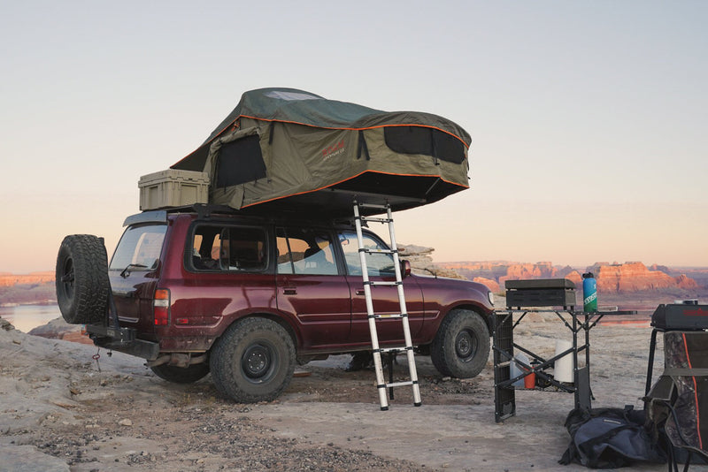 Load image into Gallery viewer, Vagabond Rooftop Tent in Forest Green Hyper Orange shown on Toyota Land Cruiser
