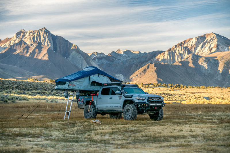 Load image into Gallery viewer, Vagabond Rooftop Tent in Slate Grey Navy Blue with ladder on a Toyota Tacoma
